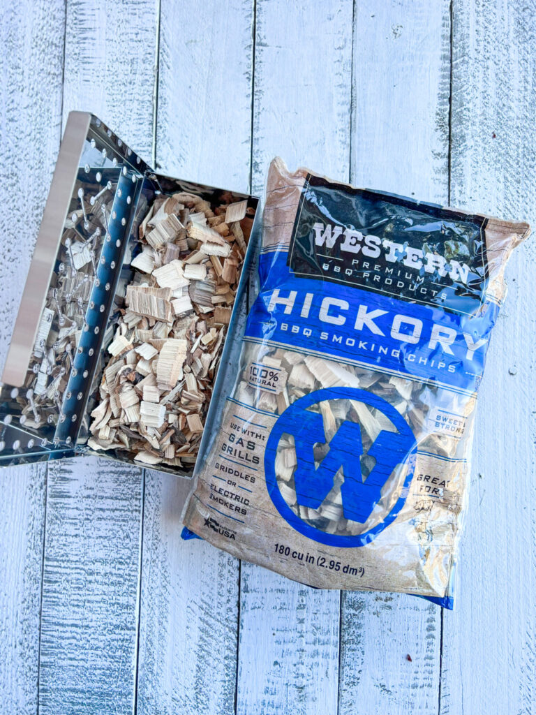 Western Premium Hickory wood chips in a bag with wood chips in a smoker container for the grill