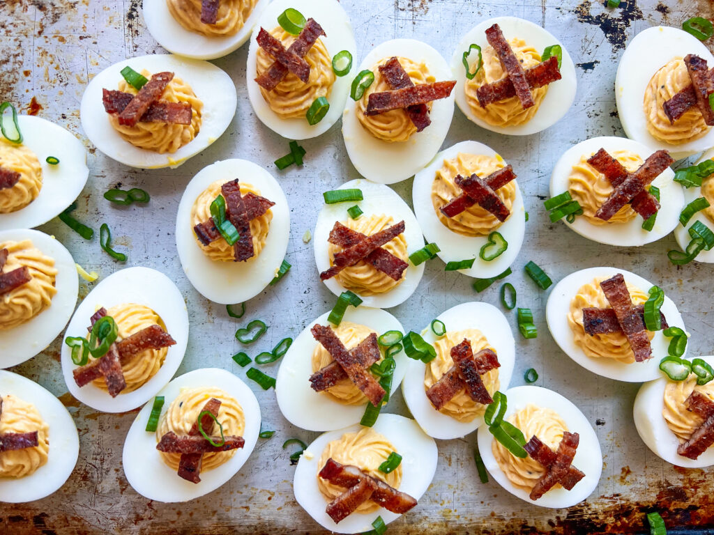 Smoked Deviled Eggs with Smoked Bacon Candy and Green onions