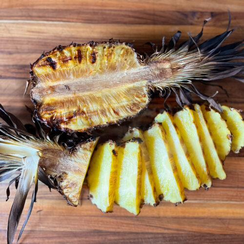 smoked pineapple with one half whole, and other half sliced