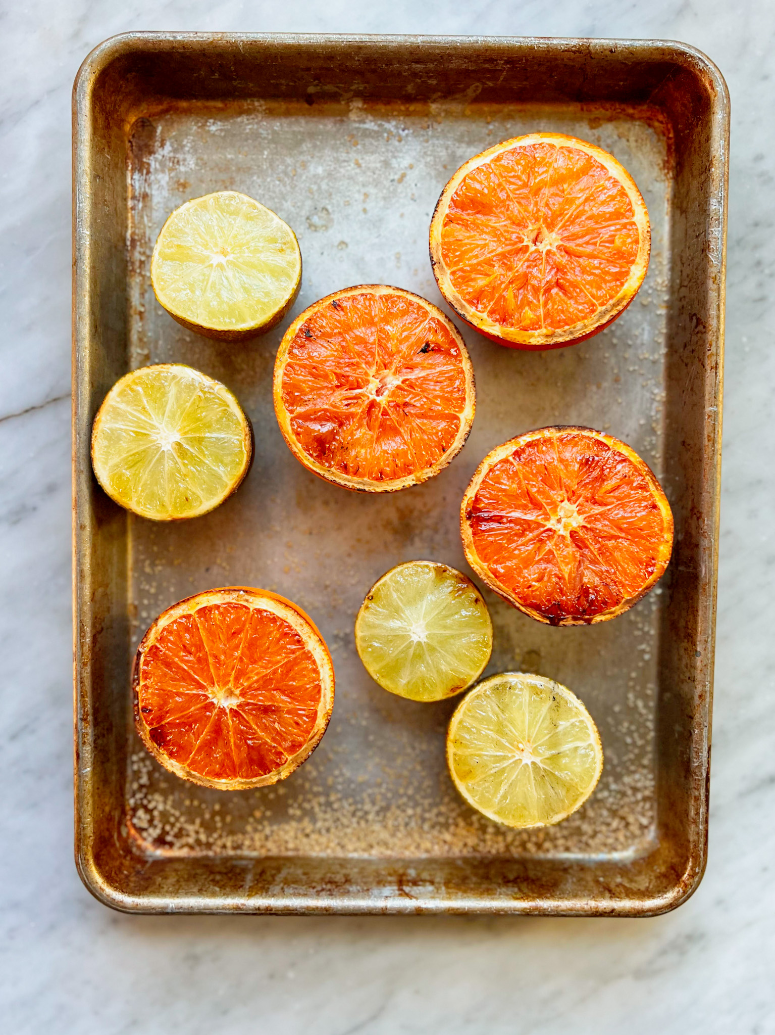 smoked oranges and limes on a sheet pan