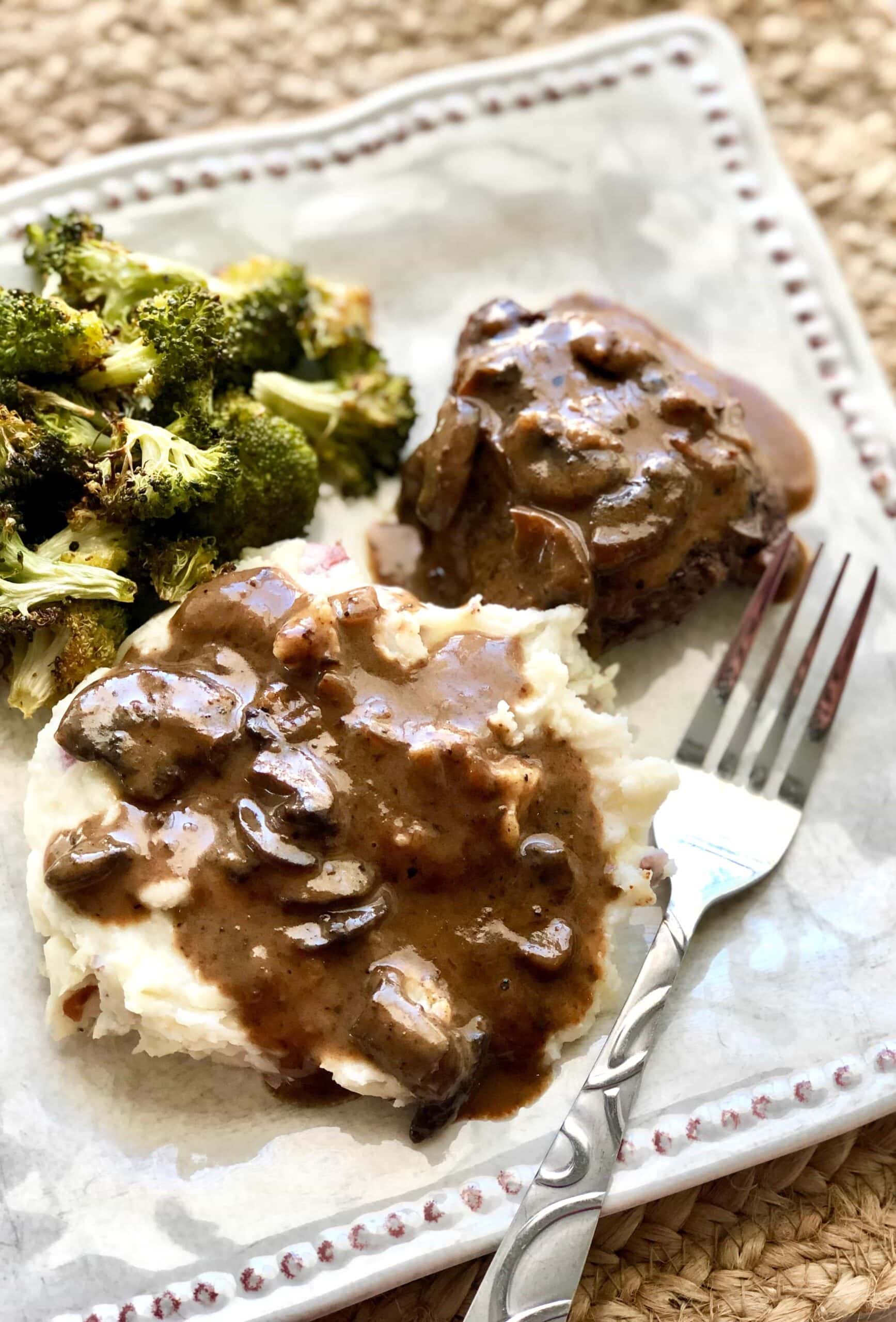 beef tenderloin marsala on plate with potatoes and broccoli