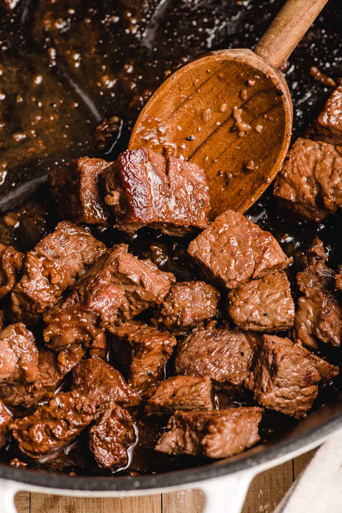 hibachi steak in a pan with a wooden spoon
