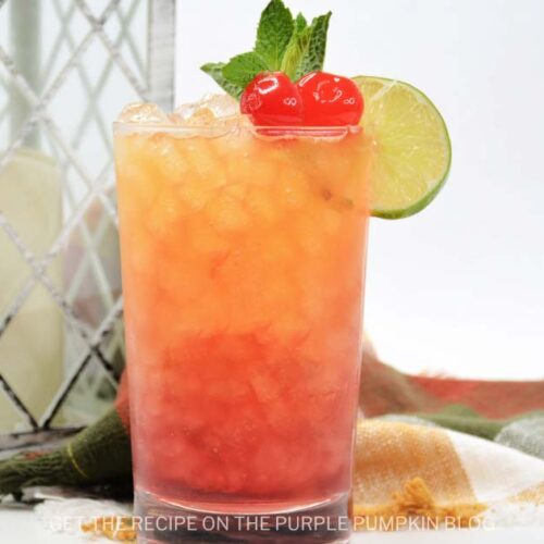 Campfire cocktail with 2 cherries and mint and a lime wedge