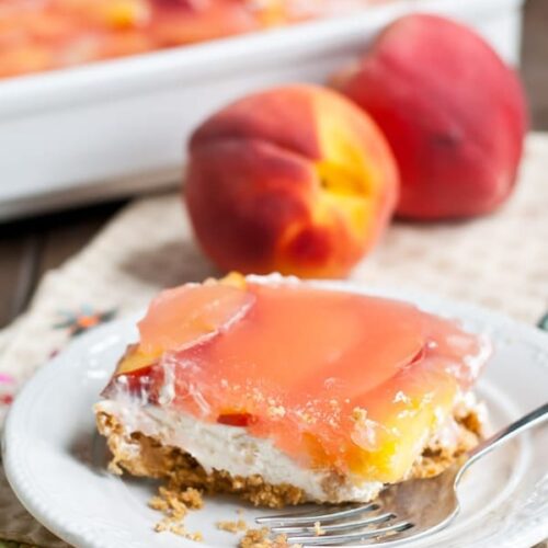 no bake peach delight on a plate with 2 peaches