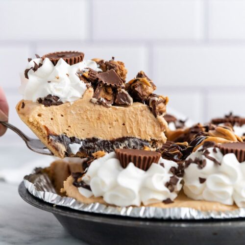 Reeses pie with a slice being cut out of it