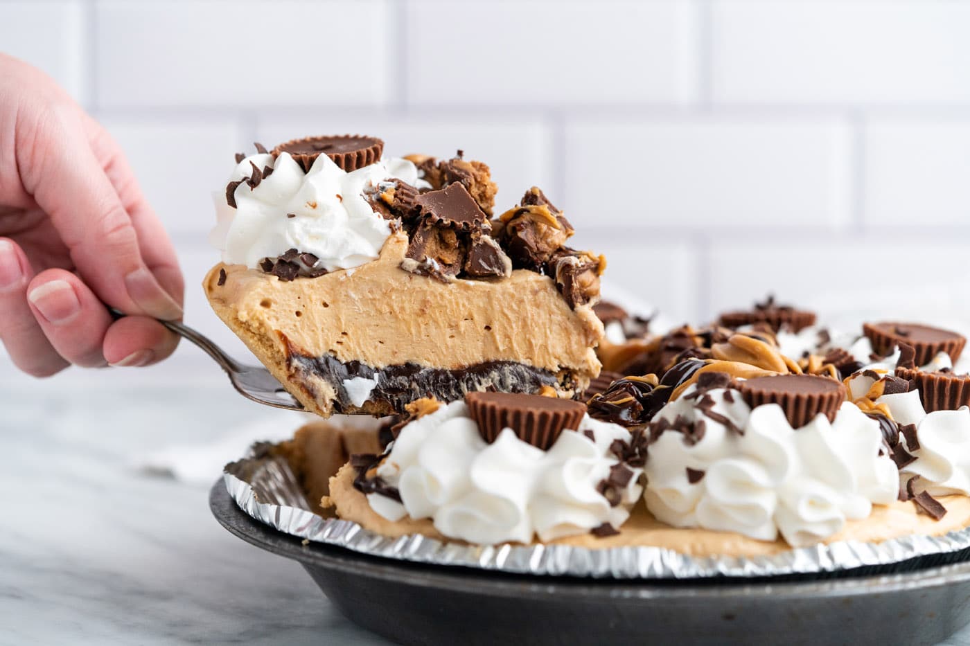 Reeses pie with a slice being cut out of it
