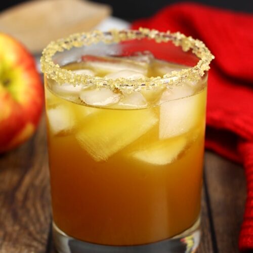 apple pie cocktail over rocks with an apple