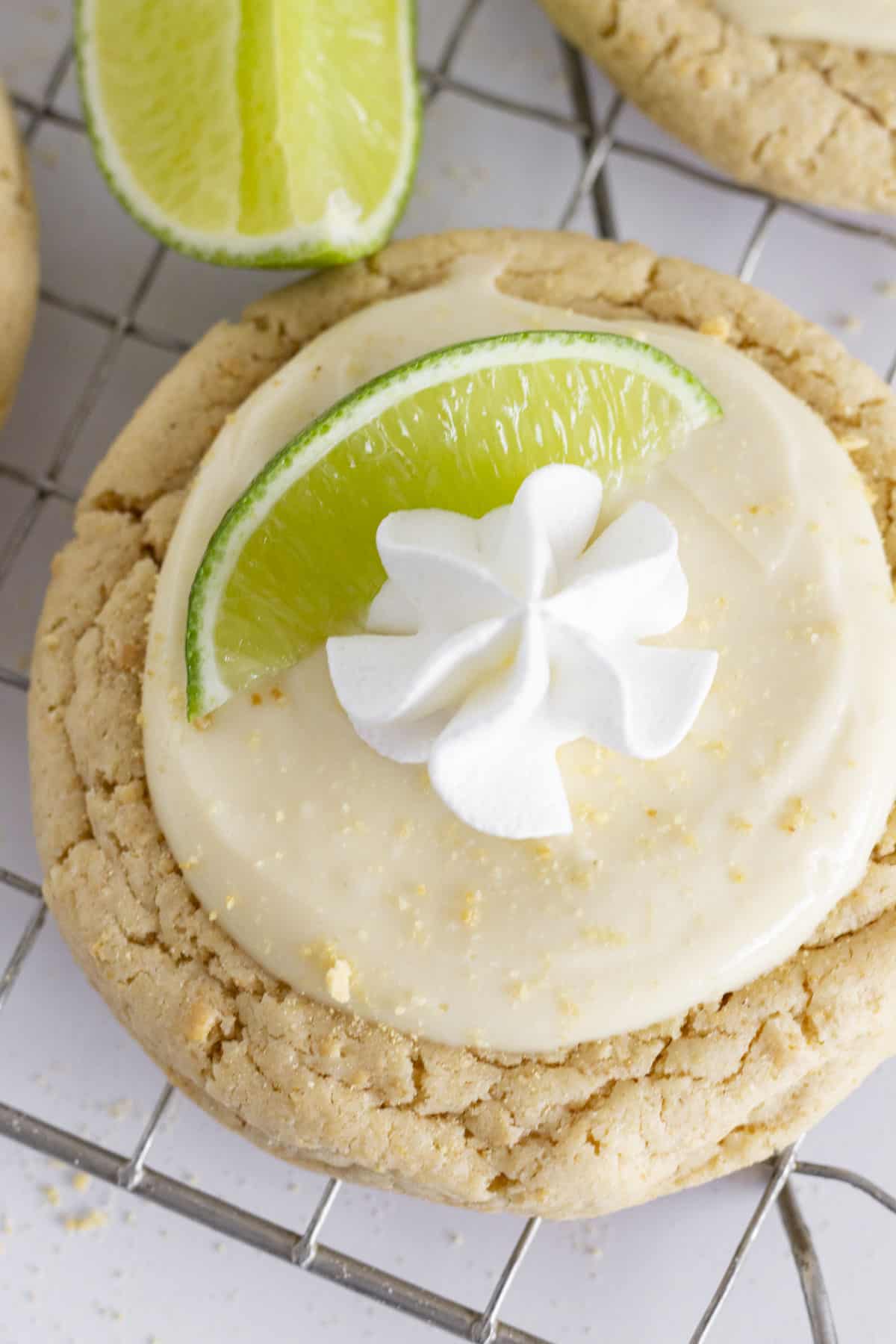 key lime cookie with frosting whipped cream and a lime slice