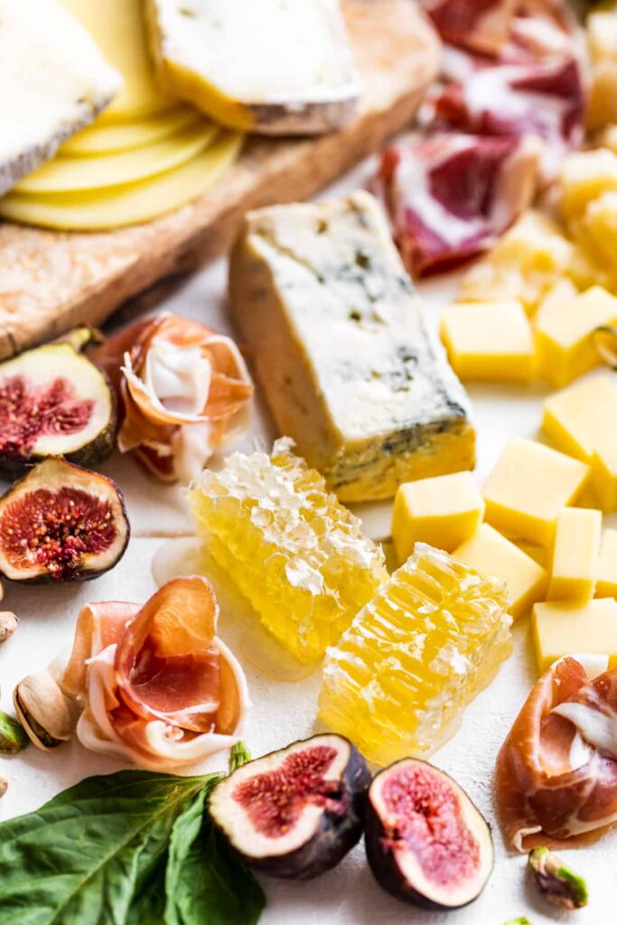 antipasto platter with cheese, figs, meats and honeycomb