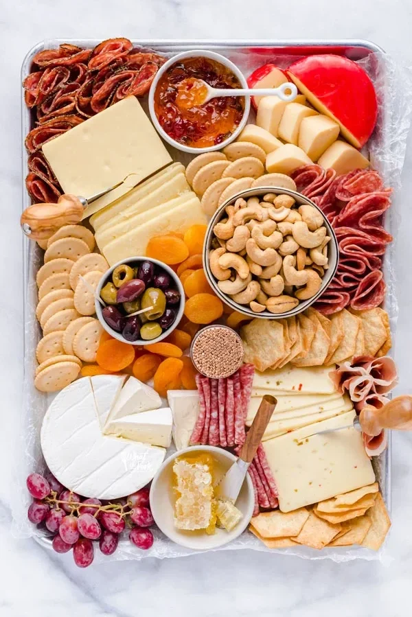 Gluten free charcuterie board with nuts and crackers and meat