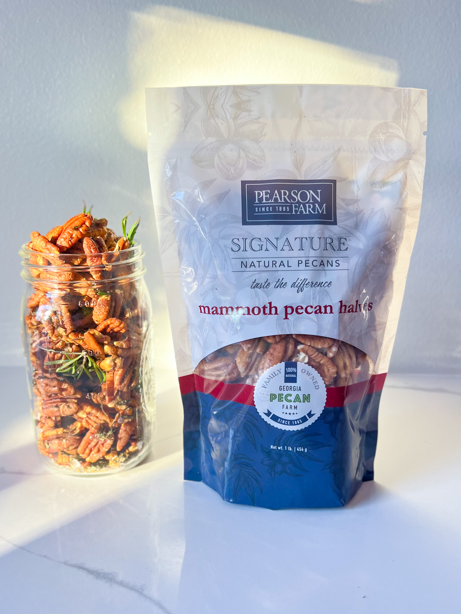 pearson farm mammoth pecans in a bag and roasted pecans with rosemary in a mason jar