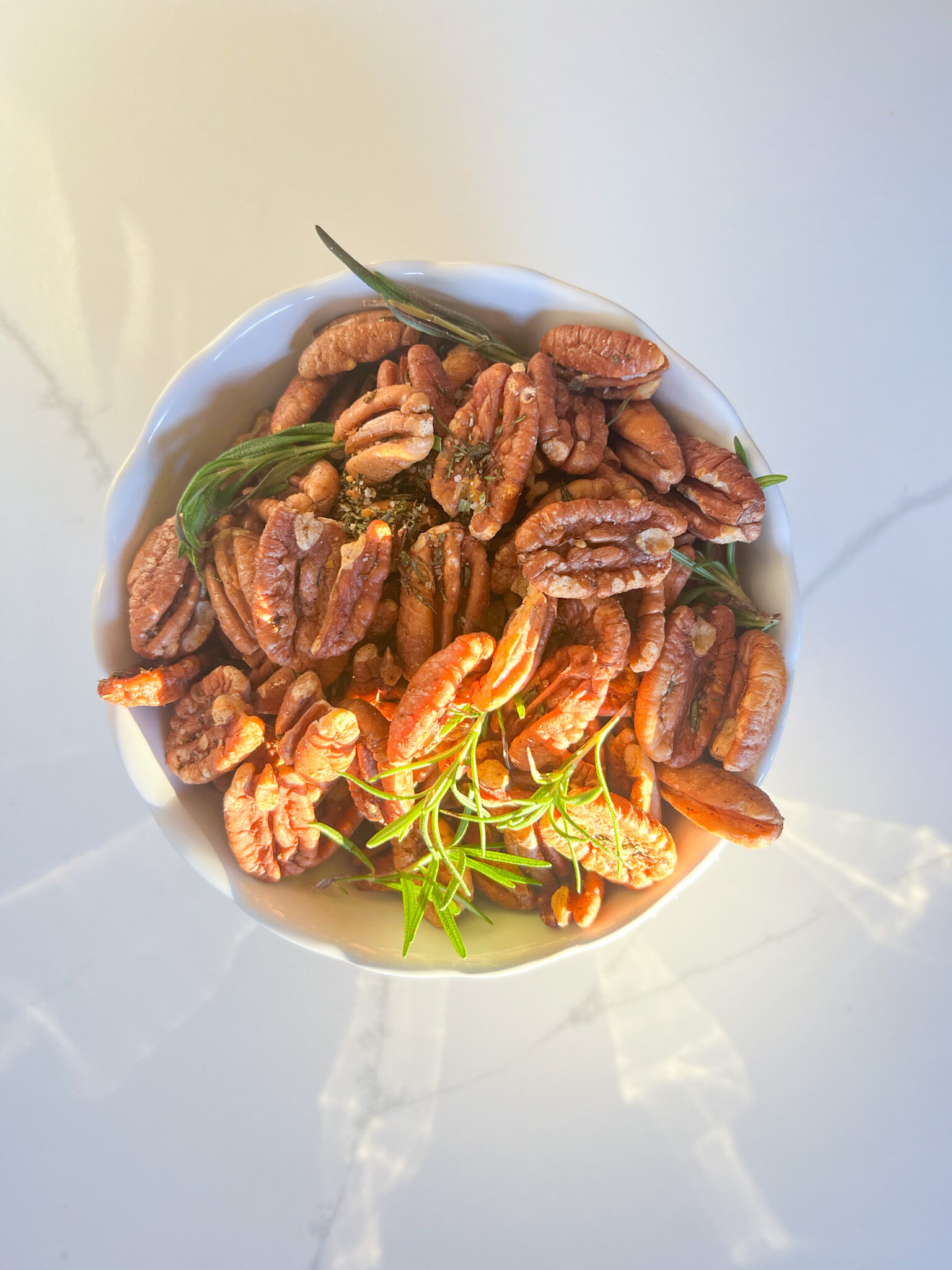 bowl of roasted pecans with rosemary