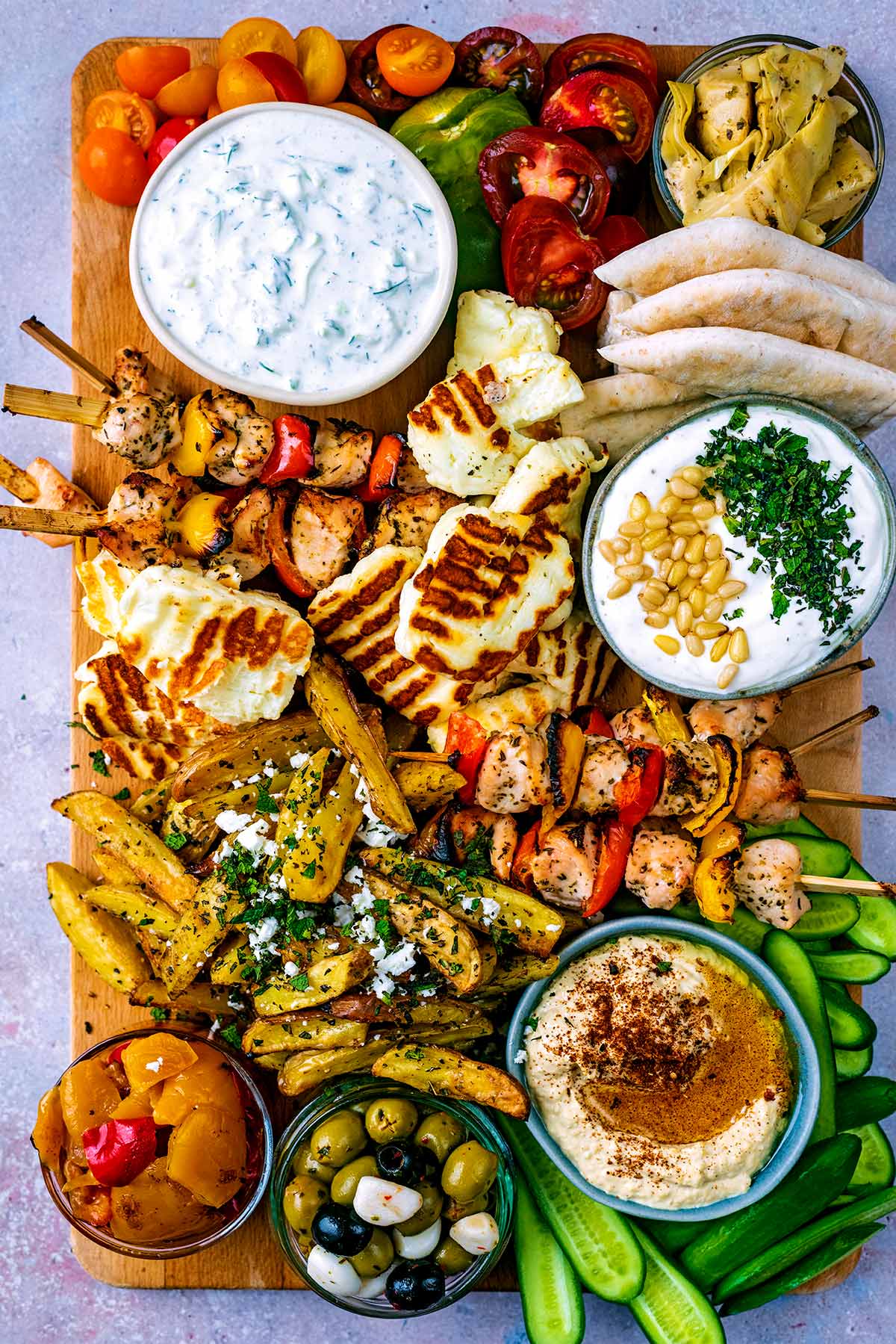 Greek meze platter with hummus, olives, meats and veggies