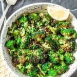 air fryer broccoli in a dish with a lemon