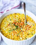 texas cream corn in a round dish with a spoon