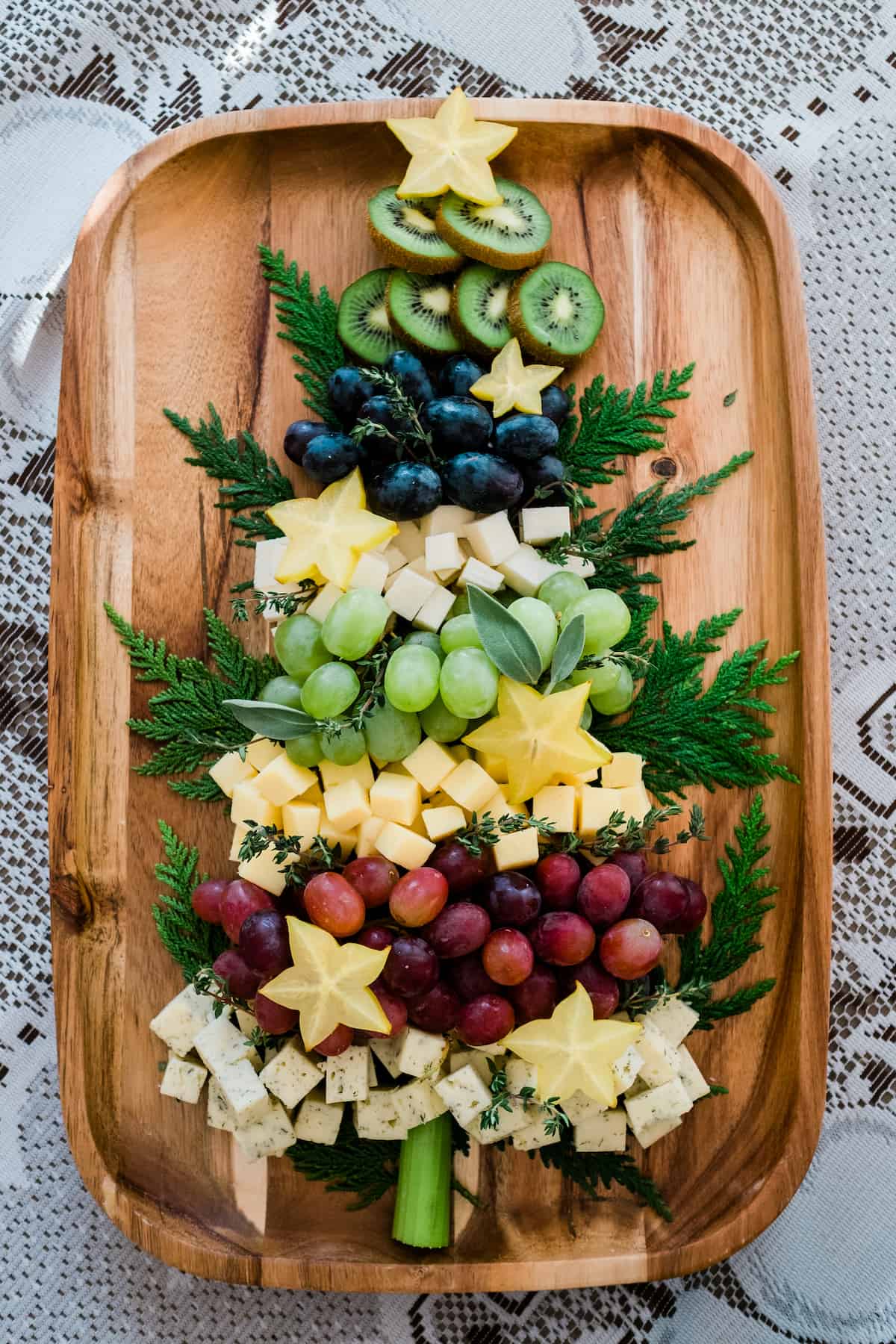 christmas tree charcuterie board with fruit and meat and cheese