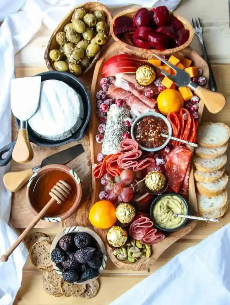 Holiday charcuterie board with cheeses, meats oloves nad crackers
