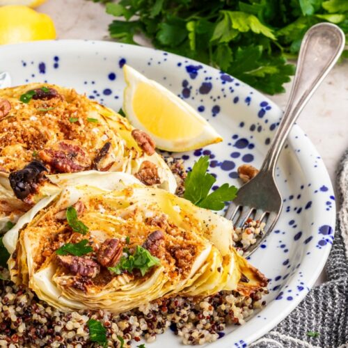 roasted cabbage steaks on a plate with lemon