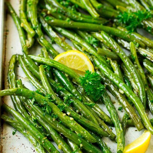 roasted green beans and lemon on a sheet pan