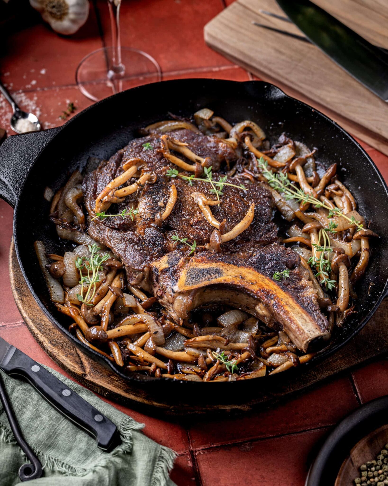 Mushroom, onion ribeye steak in a cast iron pan.