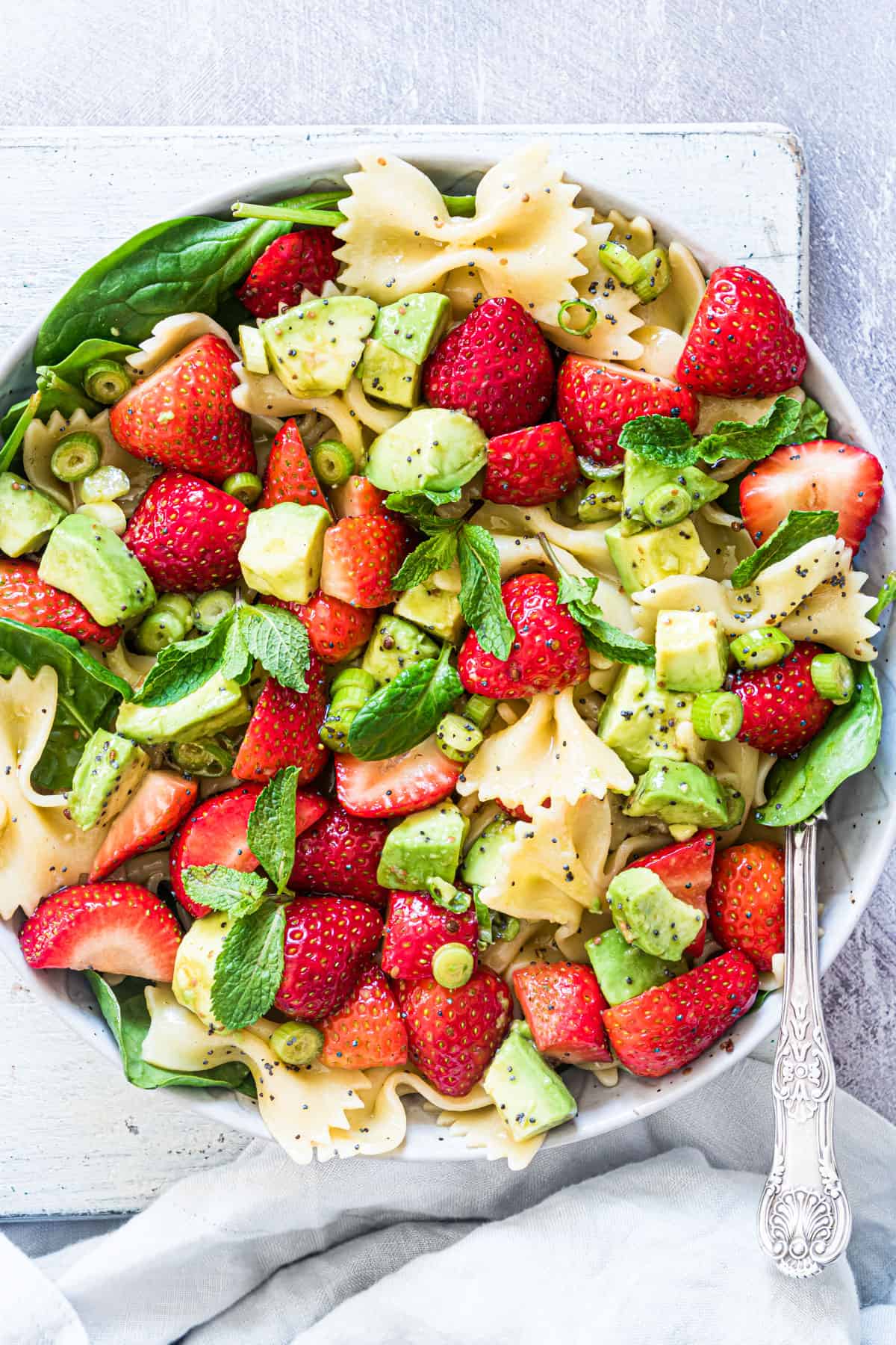 Strawberry avocado pasta salad on a plate