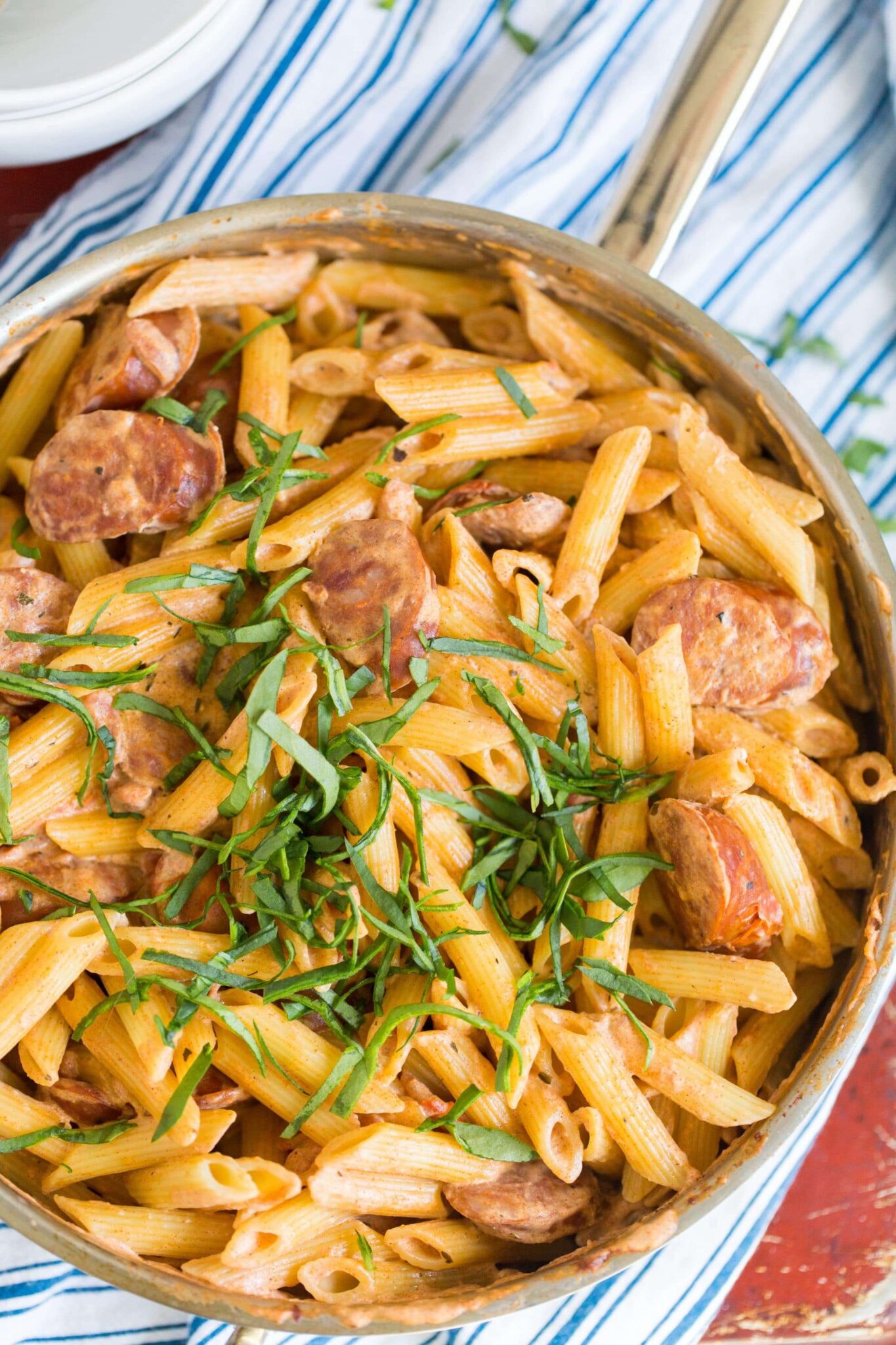 Cajun sausage pasta in a bowl with herbs
