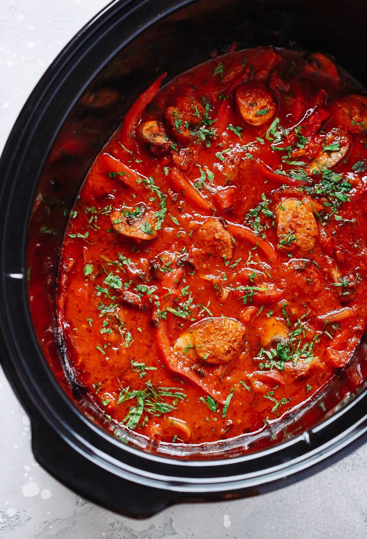 Italian sausage with peppers and tomato sauce in a slow cooker