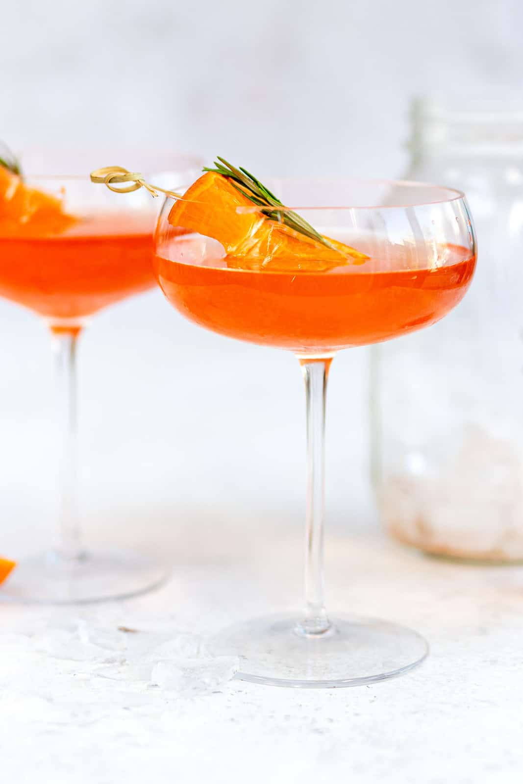 2 aperol and tequilla martinis with fruit garnishes