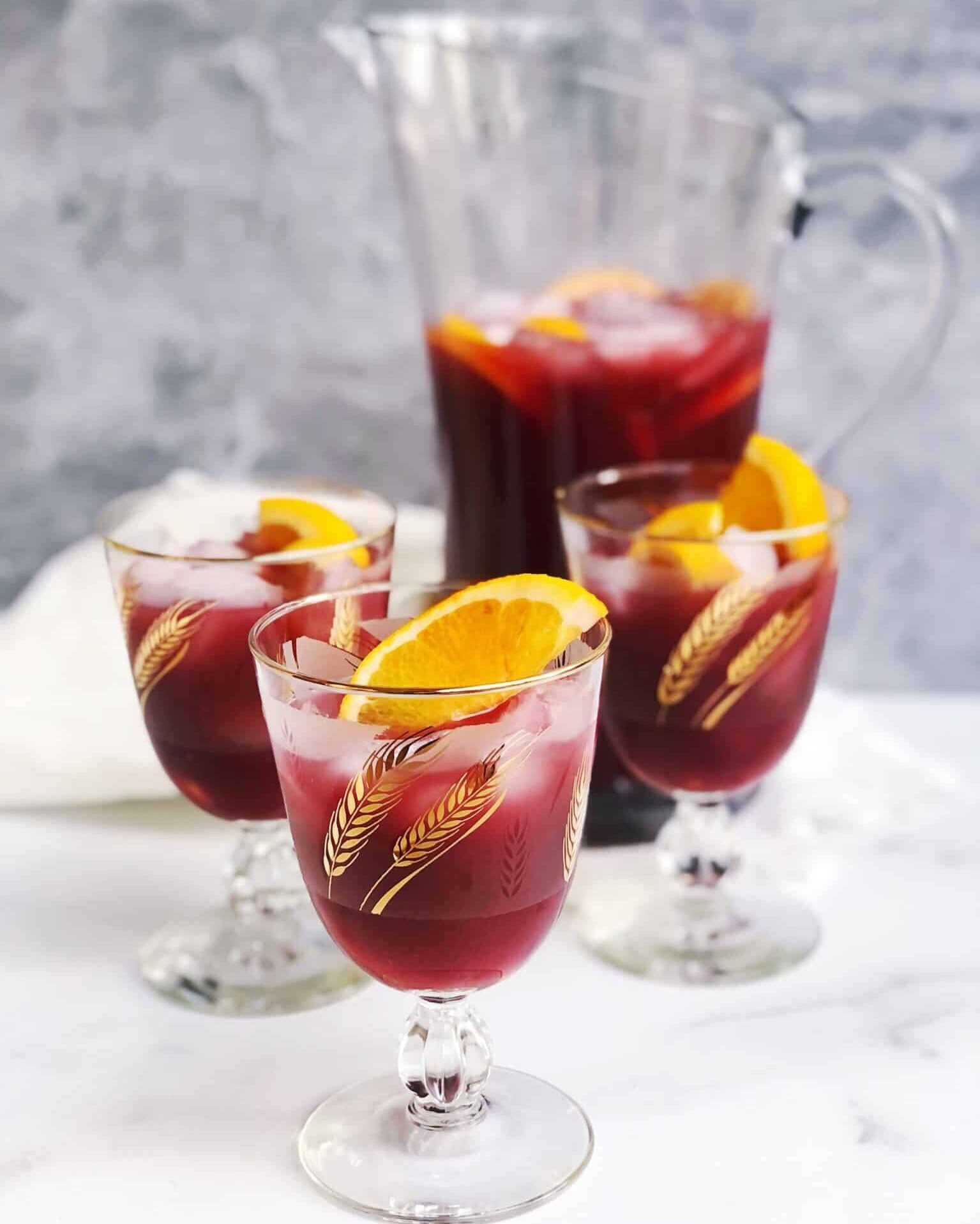 aperol and sangria in 3 glasses and a pitcher