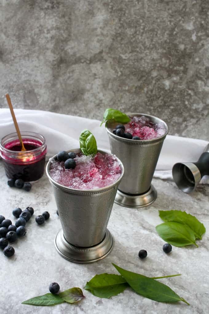 2 blueberry bourbon smashes with mint in mint julip cups