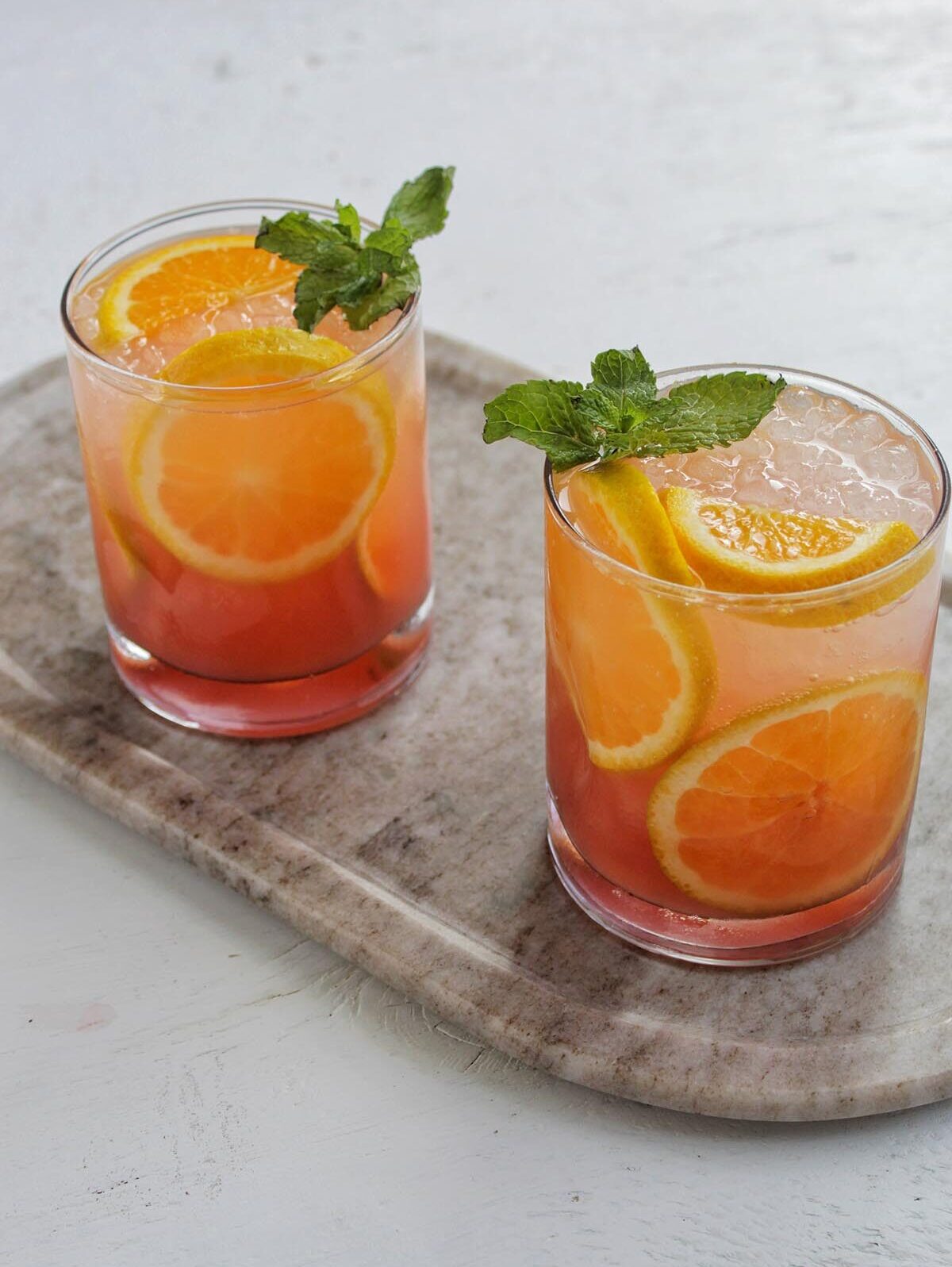 blackberry orange cocktail refresher with titos-2 glasses with orange garnish