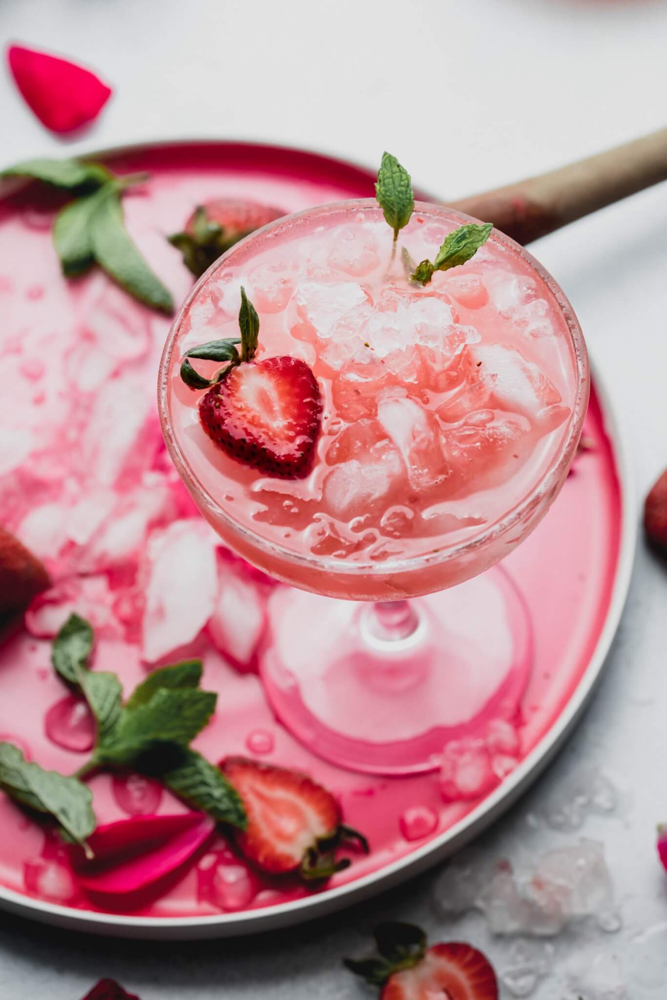 Strawberry white wine spritzer in a martini glass with strawberries